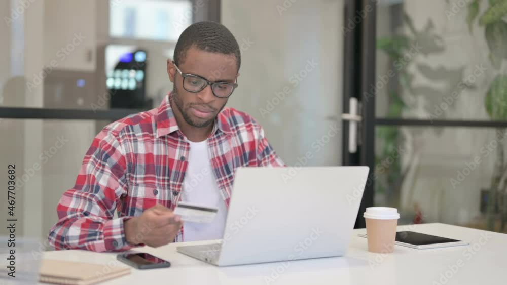 African Man making Successful Online Payment on Laptop African Man making Successful Online Payment on Laptop