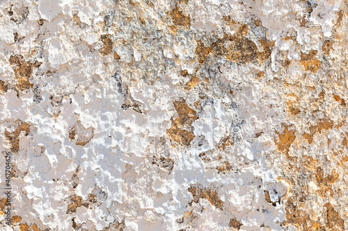 background of old plaster wall with peeling colors in white and orange © travelview