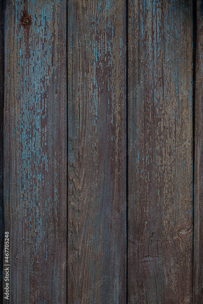 fragment of a fence made of old wooden boards with remnants of paint and nails, natural texture fragment of a fence made of old wooden boards with remnants of paint and nails, natural texture