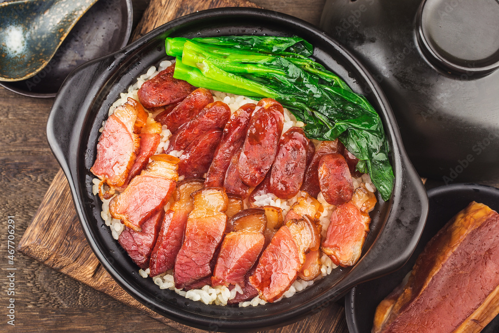 Cantonese style cooking of claypot rice with waxed meats Cantonese style cooking of claypot rice with waxed meats