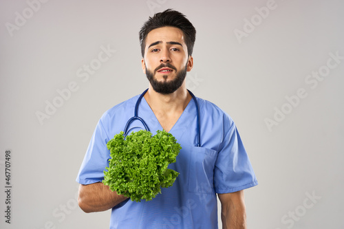 Cheerful dietitian doctor with vegetables in hands stethoscope treatment