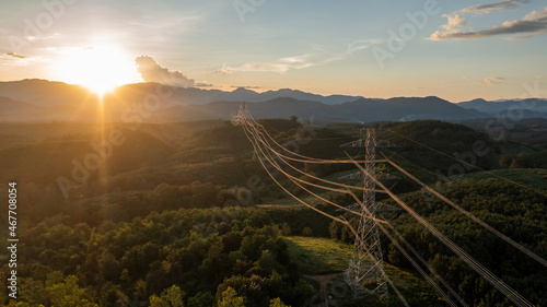 aerial view of a large high voltage light pole international power transmission On a warm day, at sunset