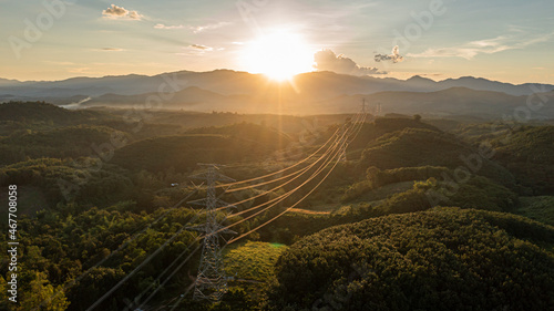 aerial view of a large high voltage light pole international power transmission On a warm day, at sunset