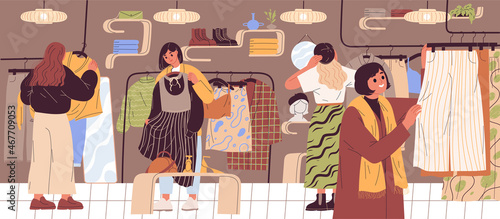 Women choosing and buying clothes at clothing store.
