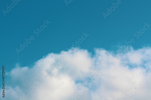 Blue peaceful Sky with fluffy clouds wallpaper. Idea for backdrop design