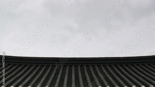 Clouds move over the traditional korean confucian school roof.