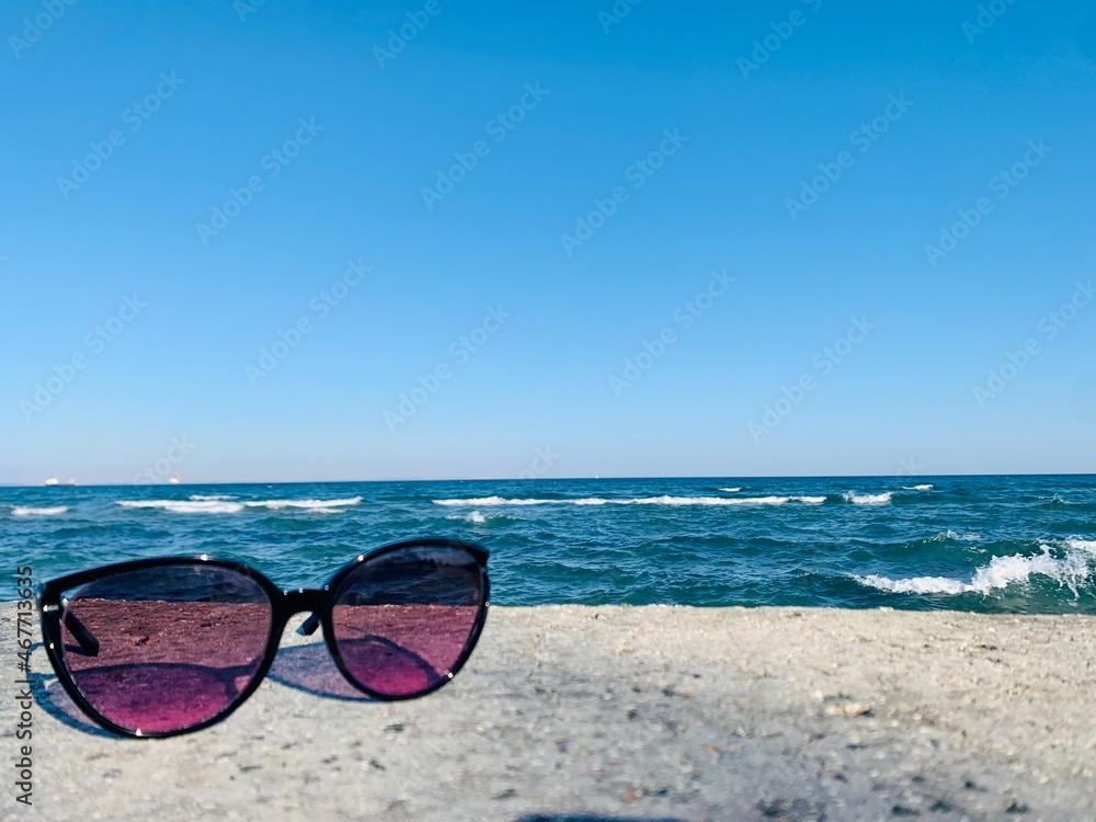 sunglasses on the beach on sea background