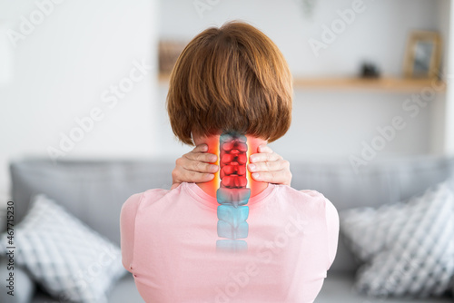 Intervertebral hernia of the cervical spine, neck pain, woman suffering from backache at home, spinal disc disease photo
