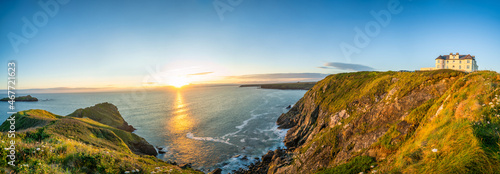 Love rock cliffs panorama of Mullion Cove at sunset in Cornwall. United Kingdom photo