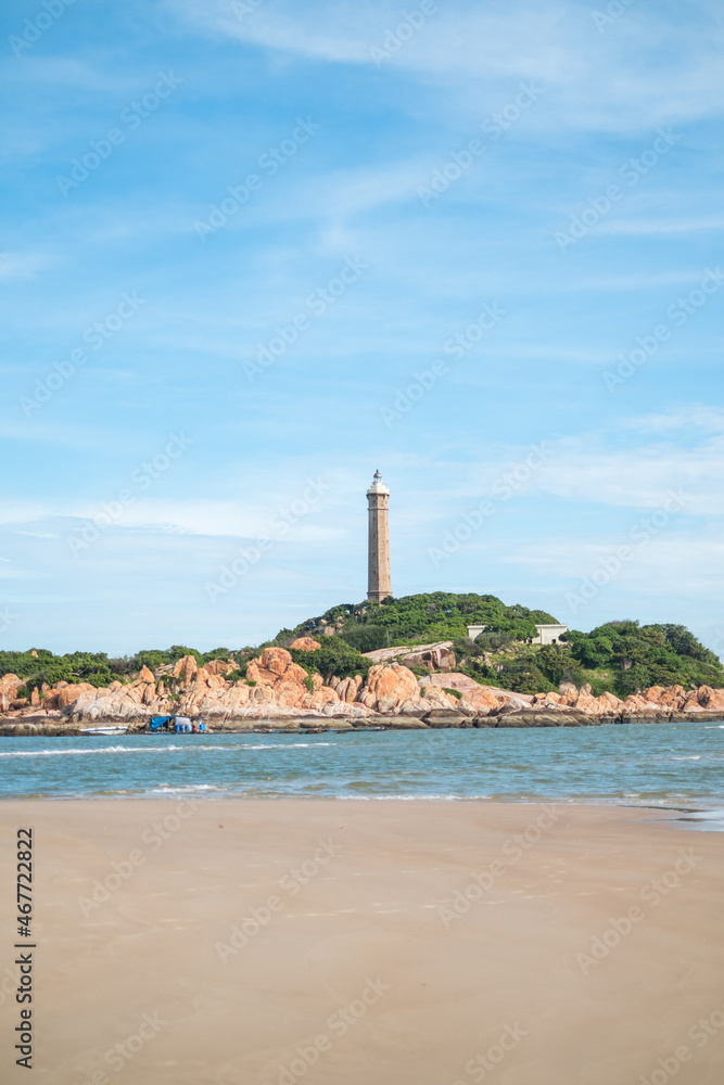 Scenic view of the lighthouse on the beautiful shore with large stones. The beauty of nature. Amazing places in the world. bay with crystal water Scenic view of the lighthouse on the beautiful shore with large stones. The beauty of nature. Amazing places in the world. bay with crystal water