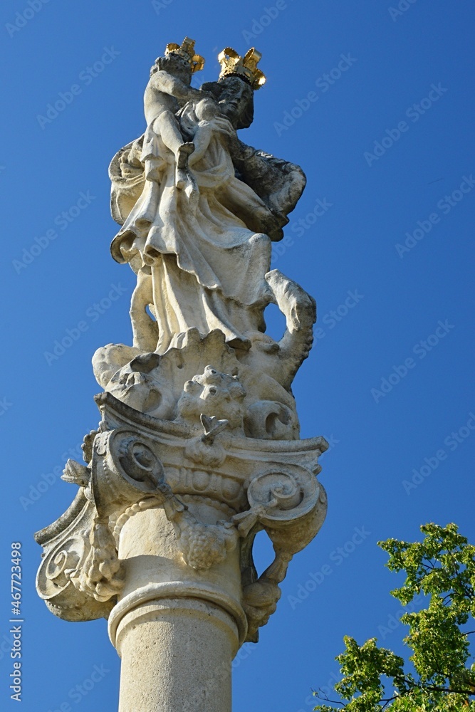 Baroque plague column in Skalica, Slovakia, with statiue of Virgin Mary with Child, built around year 1965. Summer clear blue skies, daylight sunshine.