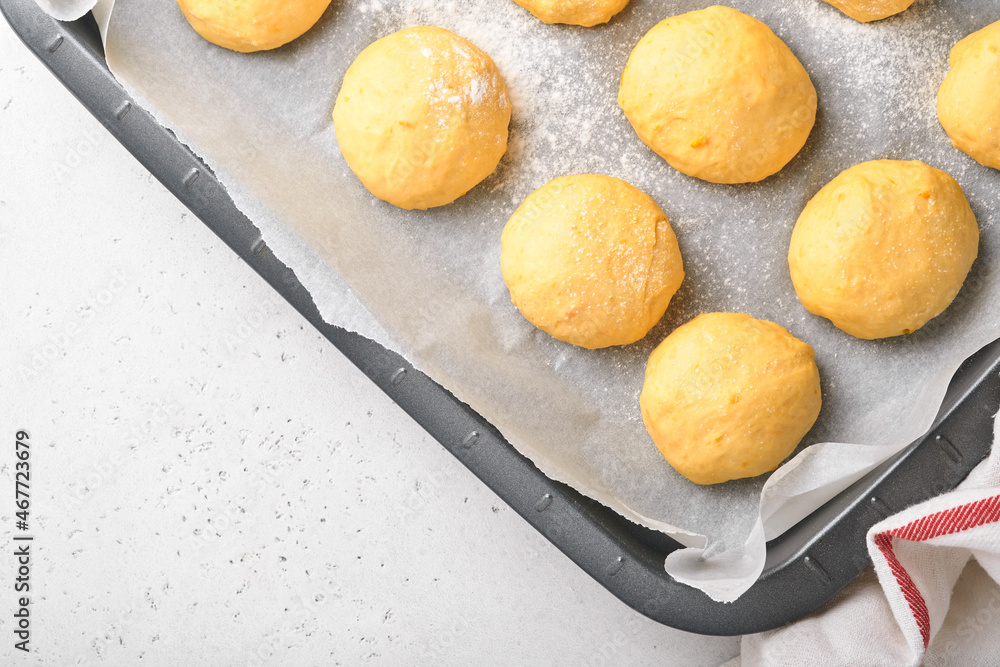 Raw yeast dough balls background in frying pan before baking. Concept home baking bread, buns or cinnabon or making dough. Raw yeast dough balls background in frying pan before baking. Concept home baking bread, buns or cinnabon or making dough.