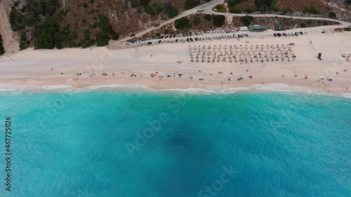 Aerial view of people sunbathing at the exotic turquoise sea of Myrtos beach at Kefalonia island, Greece photo