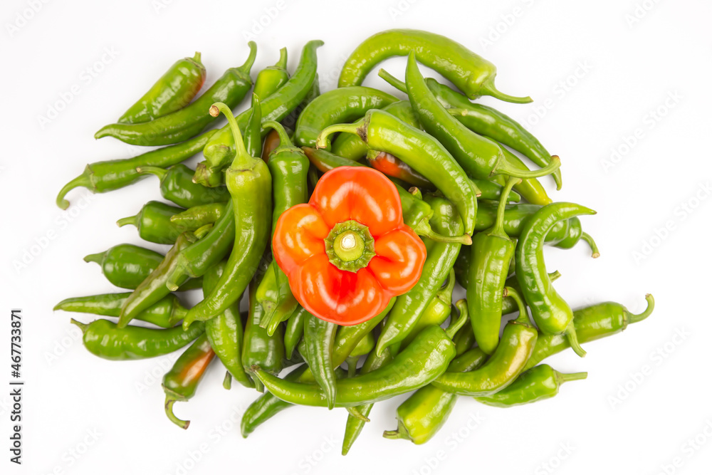 green hot peppers and red bell peppers on a white background. vitamin vegetables for health green hot peppers and red bell peppers on a white background. vitamin vegetables for health