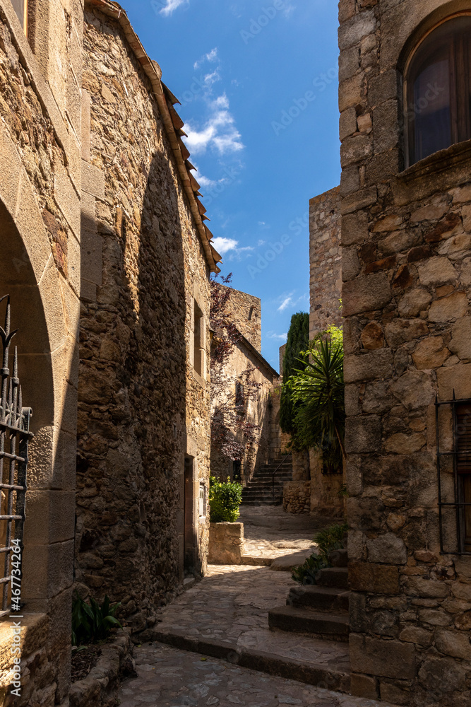 narrow stone street with stairs in the medieval village of pals on the costa brava narrow stone street with stairs in the medieval village of pals on the costa brava