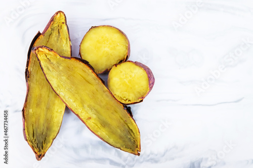 Japanese sweet potato sliced on marble stone. Ready to eat. Potatoes contains a fiber, thiamin, calcium, potassium, and vitamins A and C.  photo