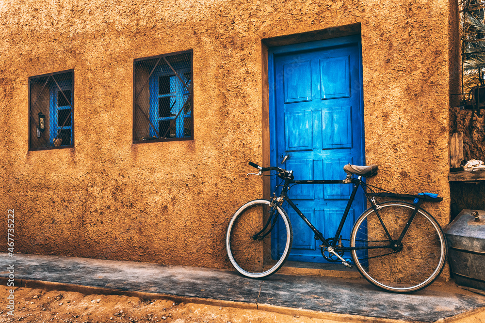 old bicycle in front of a house old bicycle in front of a house