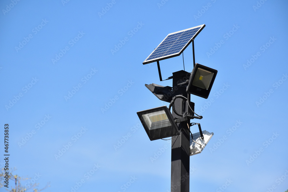 Photovoltaic panel which installed on the top of the metal pole to store and use the sun power around the public park at night. Photovoltaic panel which installed on the top of the metal pole to store and use the sun power around the public park at night.