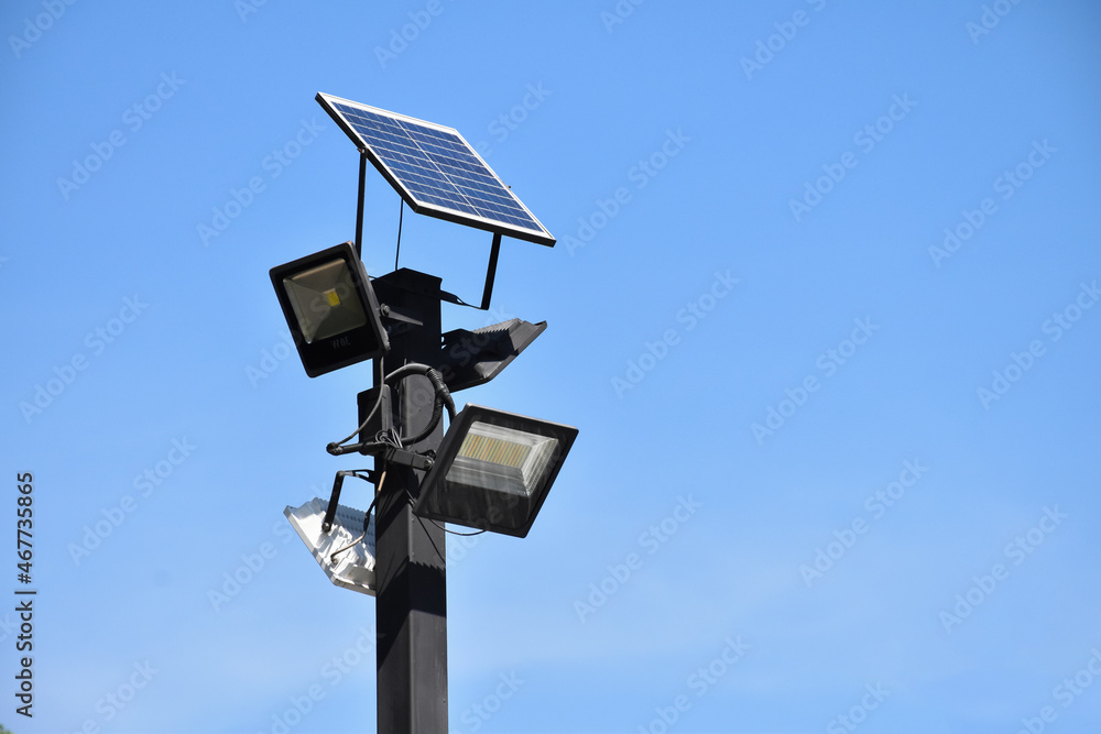 Photovoltaic panel which installed on the top of the metal pole to store and use the sun power around the public park at night. Photovoltaic panel which installed on the top of the metal pole to store and use the sun power around the public park at night.