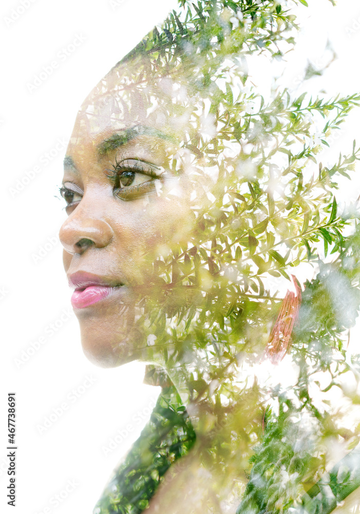 A portrait of a woman dissolving into green twigs. Double exposure technique.