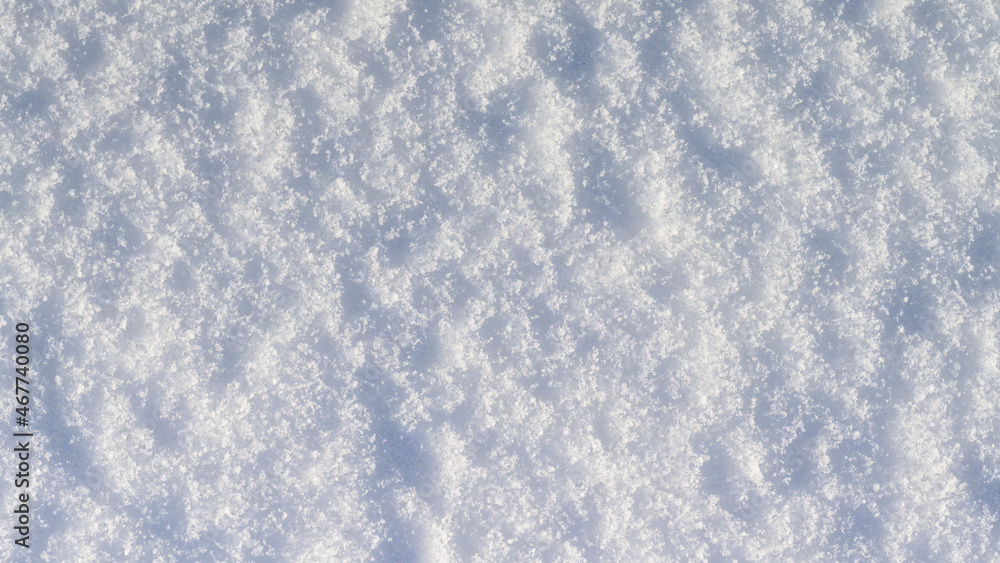 Winter snow background, ice crystals sparkling on snow, christmas texture, sparkling snowflakes in snowdrift.