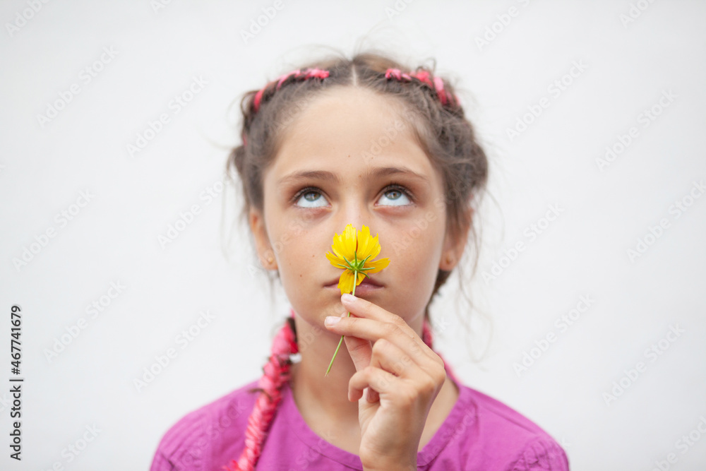 Little girl sniffing yellow flower Little girl sniffing yellow flower