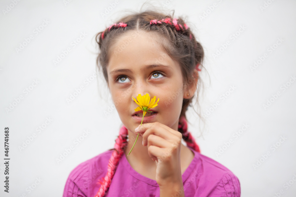 Little girl sniffing yellow flower Little girl sniffing yellow flower