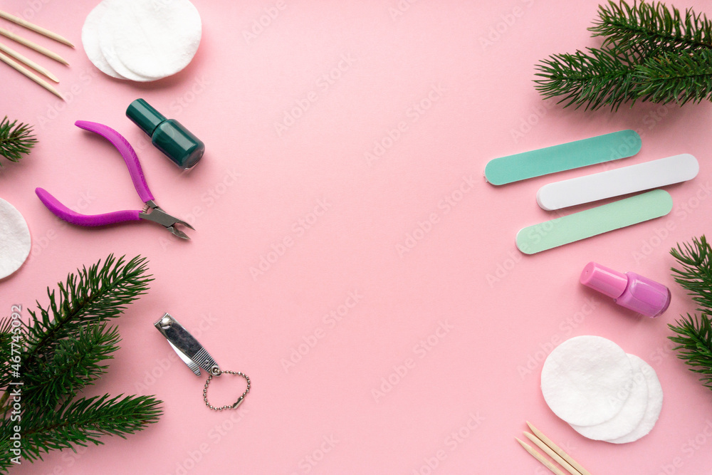 Christmas flat lay of manicure accessories with fir branches on pink background, top view Christmas flat lay of manicure accessories with fir branches on pink background, top view