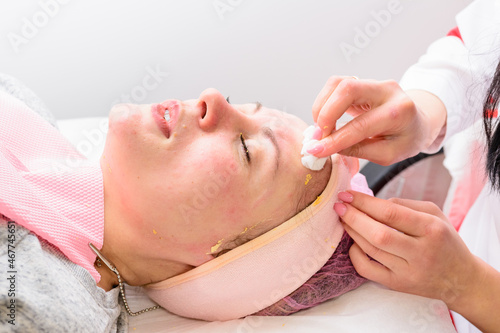 Facial massage at the beautician at the reception, visiting a beauty salon, a sense of relaxation.