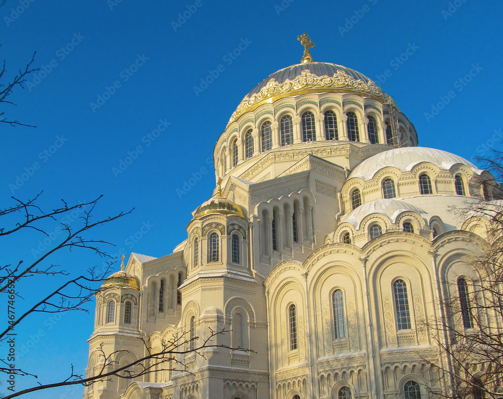 The Naval Cathedral of Saint Nicholas (Marine Cathedral) in Kronstadt, St. Petersburg, Russia on a winter day. Beautiful building with the illuminated sun against the blue sky.