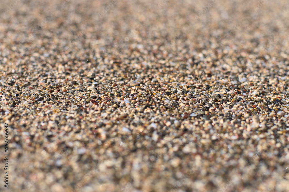 Beach sand of small, tiny pebbles and seashells Beach sand of small, tiny pebbles and seashells