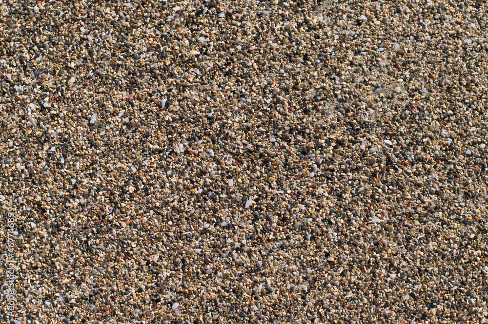 Beach sand of small, tiny pebbles and seashells Beach sand of small, tiny pebbles and seashells