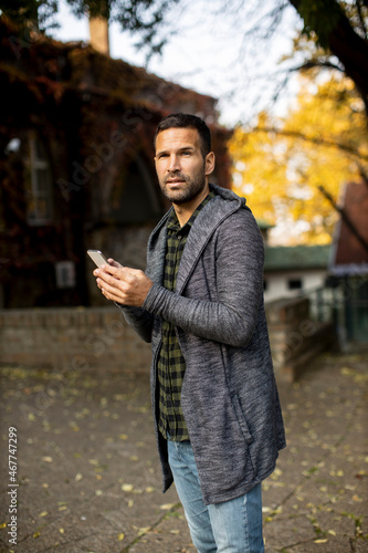Young man using mobile phon...