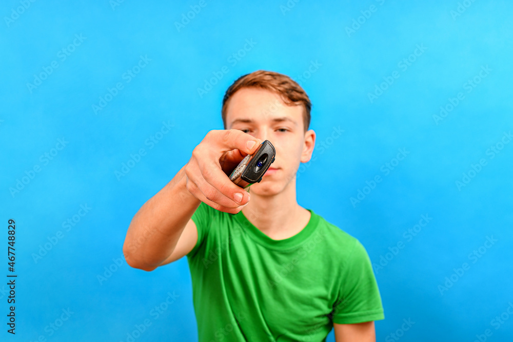 The teenager took out his hand with the remote control. The teenager took out his hand with the remote control.