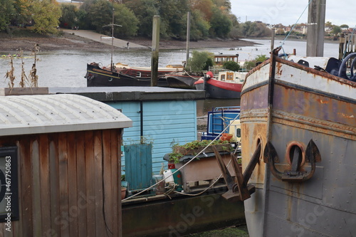 rusty anchor and river boats on the River Thames