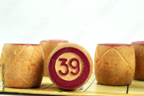 Family board game Lotto. Wooden barrels loto numbered 39 on a white background