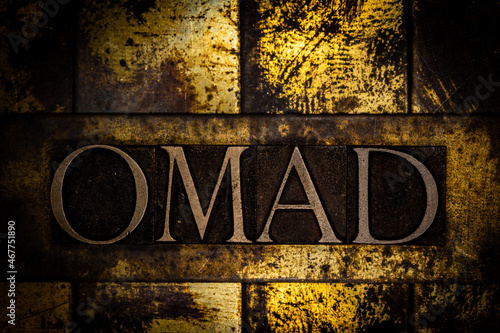 OMAD text on textured grunge copper and vintage gold background