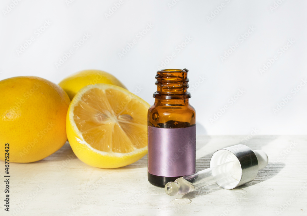 The concept of natural care cosmetics
with a bottle of essential oil and serum on a white background and with lemon and green leaves. Flat composition with cosmetic products with place for text. The concept of natural care cosmetics
with a bottle of essential oil and serum on a white background and with lemon and green leaves. Flat composition with cosmetic products with place for text.