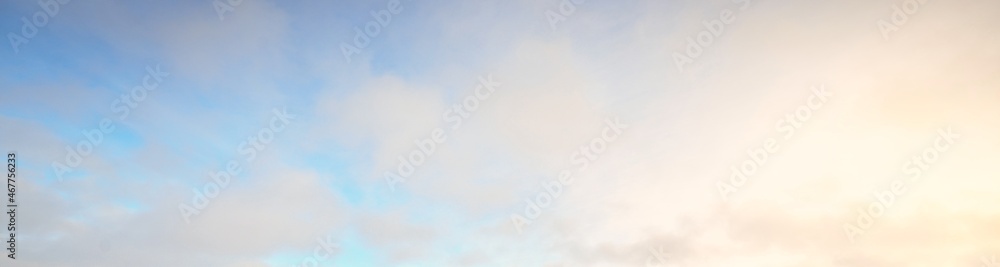 Clear sky, glowing cirrus and cumulus clouds after the storm, soft sunlight. Dramatic sunset cloudscape. Meteorology, weather, climate, heaven, peace. Graphic resources. Picturesque panoramic scenery - obrazy, fototapety, plakaty 
