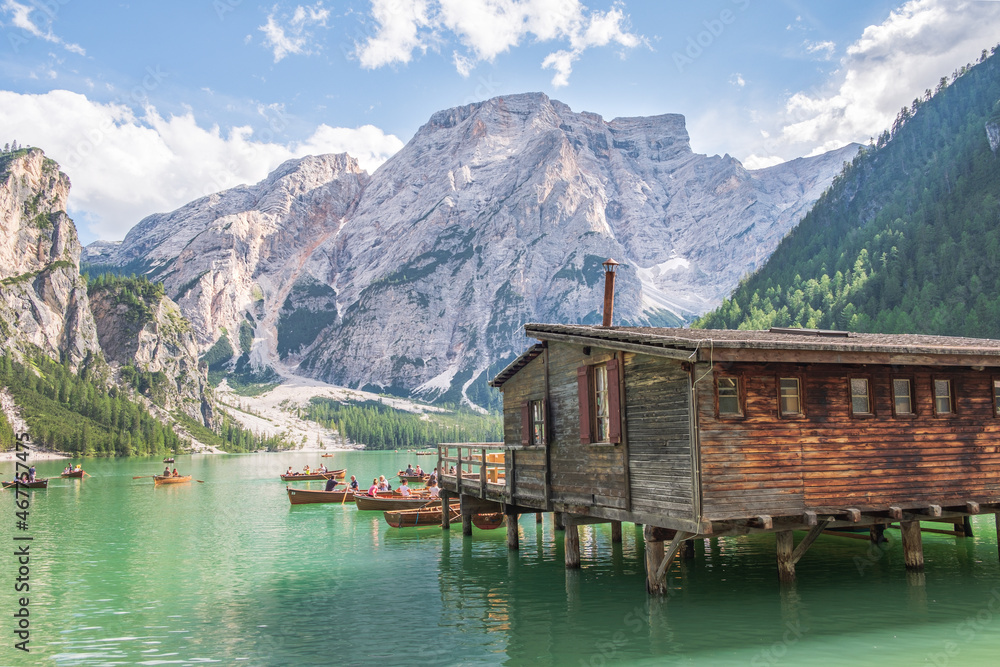 Naklejka premium Lake Braies (also known as Pragser Wildsee or Lago di Braies) in Dolomites Mountains, Sudtirol, Italy. Romantic place with typical wooden boats on the alpine lake. Hiking travel and adventure.