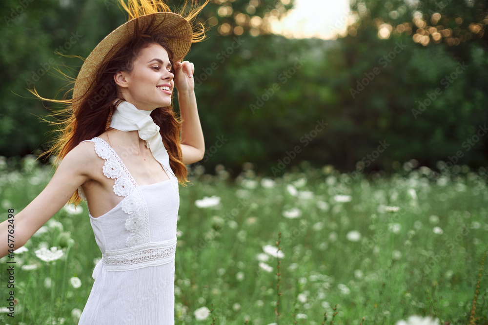 beautiful woman in a hat in a field with flowers walk beautiful woman in a hat in a field with flowers walk