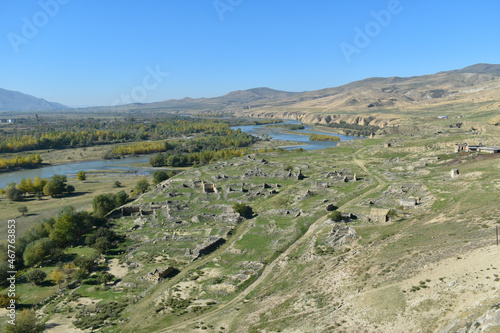 View at Mtkvari river or Kura river from the rock cave city Uplistsikhe in Georgia, Asia. River bank with autumn trees and hills in the background photo