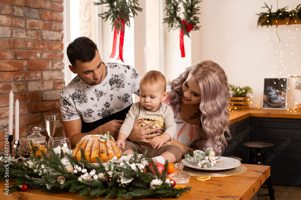 family on kitchen near nicely decorated Christmas tree, enjoying the Christmas magic. family on kitchen near nicely decorated Christmas tree, enjoying the Christmas magic.