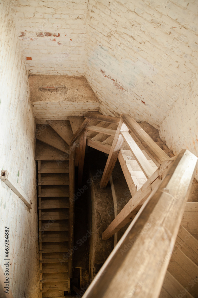 Spiral wooden staircase in a stone building. Spiral wooden staircase in a stone building.
