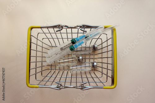 Basket with ampoules of medicines for injection  syringe. vaccination. The concept of medicine and immunity. Vaccination against viral infections. Drug and injection. cold. Injection  drug. Flatly