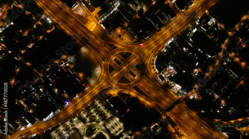 Aerial drone night slow shutter shot of urban ring multilevel interchange highway road passing through city centre