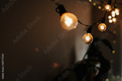 photo of a garland of light bulbs on a dark background. selective focus. christmas and new year concept 
