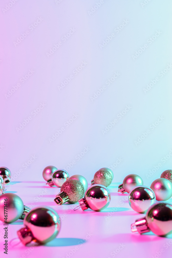 Christmas balls pattern neon background. Xmas bauble on abstract holiday winter gradient backdrop. Happy new year copy space. Christmas balls pattern neon background. Xmas bauble on abstract holiday winter gradient backdrop. Happy new year copy space.