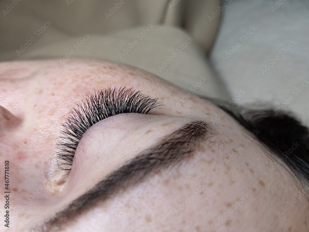 Naklejka premium Lash extensions in beauty salon macro eye 