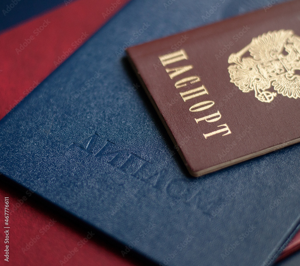 documents Russian passport and diploma on top of each other documents Russian passport and diploma on top of each other